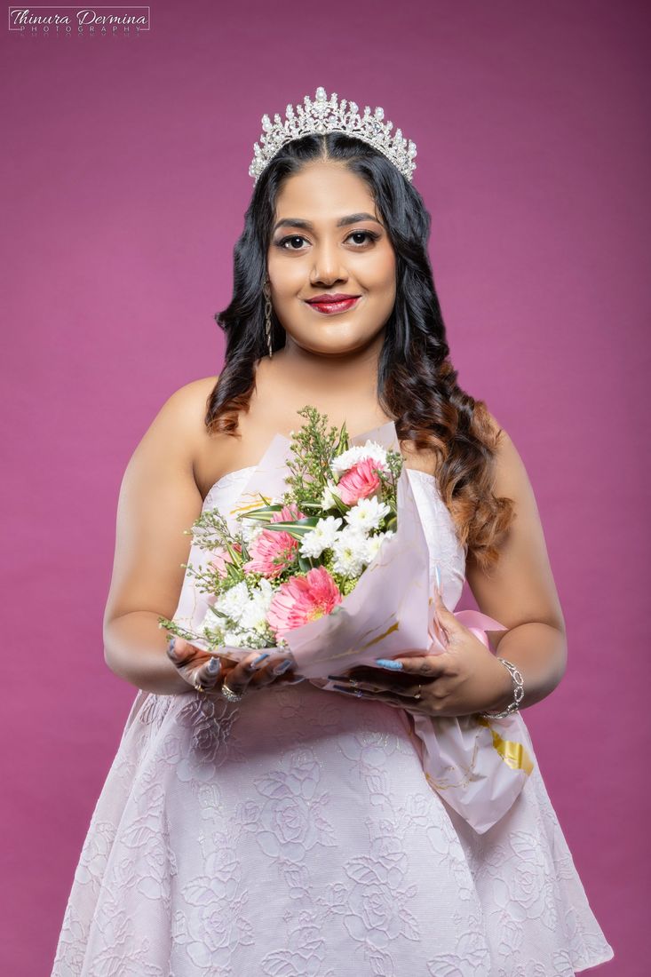 Birthday portrait in a pink gown holding a bouquet of flowers